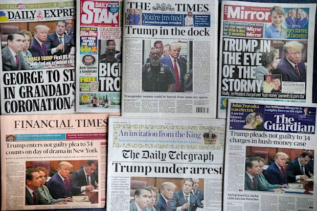 A selection of British national newspaper front pages for Wednesday April 5, 2023, in London, showing their coverage of former President Donald Trump as he appeared in court for his arraignment in New York, Tuesday. Trump surrendered to authorities Tuesday after being indicted by a New York grand jury on charges related to hush-money payments at the height of the 2016 presidential election.