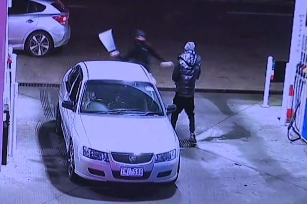 Two males are on the run after a teenager was slashed with a machete while he was refuelling at a service station in Melbourne.