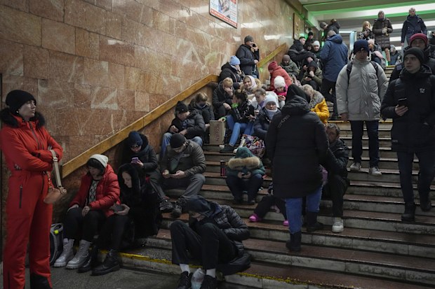 People rest in the subway station, being used as a bomb shelter during a rocket attack in Kyiv, Ukraine, Friday, Dec. 16, 2022 