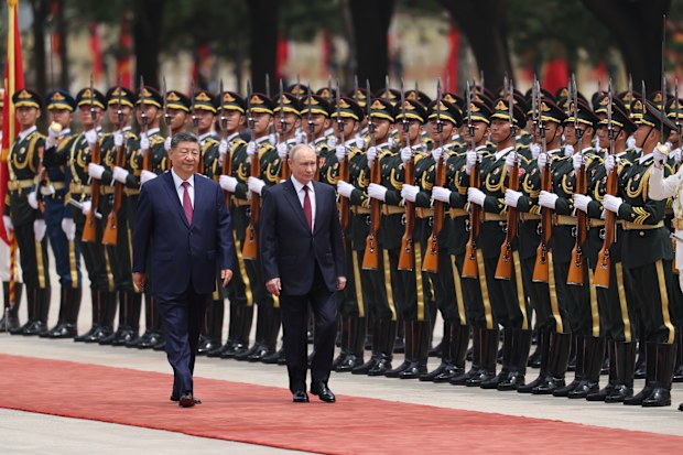 Russian President Vladimir Putin, right, and Chinese President Xi Jinping inspect an honor guard during a welcoming ceremony at the Great Hall of the People in Beijing Wednesday, May 20, 2026. (Maxim Shemetov/Pool Photo via AP)