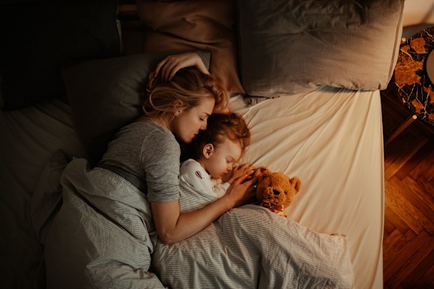 Mum sleeping next to daughter