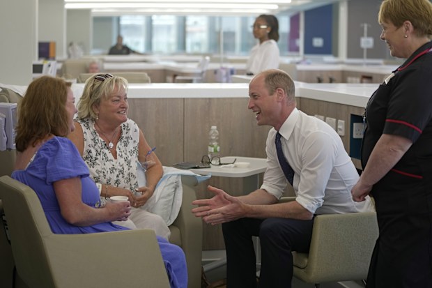 Prince William, right, talks to the patients as he attends the official opening of the Oak Cancer Centre at The Royal Marsden Hospital in London, Thursday, June 8, 2023 