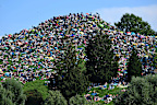 dpatop - 27 July 2024, Bavaria, Munich: Fans sit on the Olympiaberg in the Olympiapark and wait in the sunshine for the Taylor Swift concert to begin. Taylor Swift's first of two concerts in Munich as part of her "The Eras Tour" is taking place there today. Photo: Felix Hörhager/dpa (Photo by Felix Hörhager/picture alliance via Getty Images)