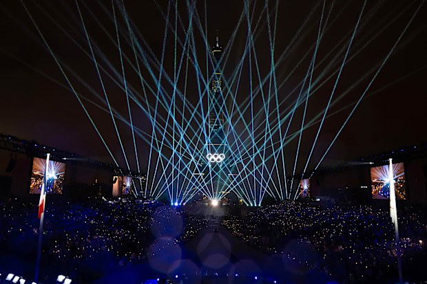 The Eiffel Tower is lit up with the Olympic Rings to close the opening ceremony.