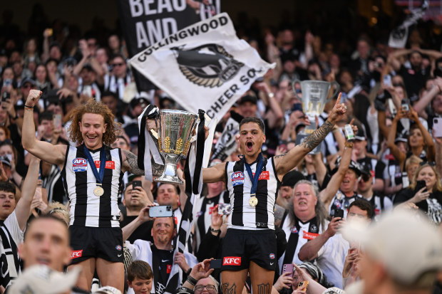 Collingwood's Beau McCreery and Bobby Hill celebrate the grand final triumph.