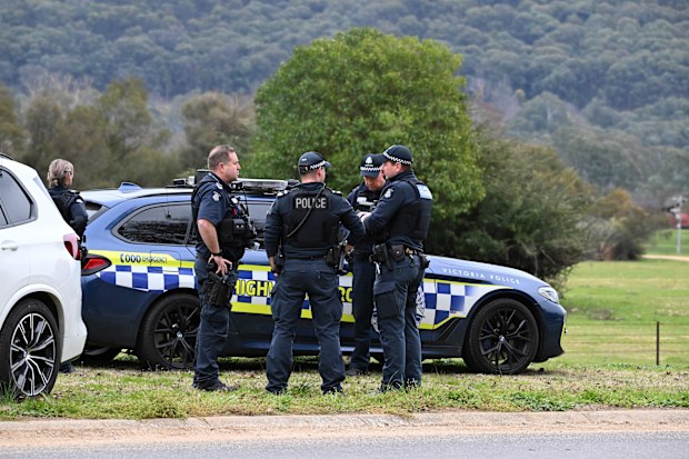 Police at the scene in Porepunkah, where two officers were shot dead and another injured while serving a warrant.