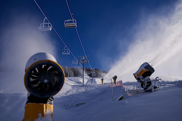 A overview of the progress of work on the construction of ski slopes and ski jumps with snow cannons in Livigno, Italy.
