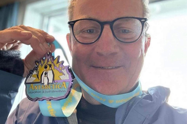 Tim Proudman with his medal after completing the Antarctica marathon.