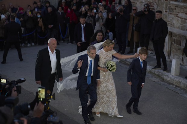 Chrysi Vardinogianni, escorted by her father Yiorgos Vardinogiannis, arrives at the Holy Church of Saint Nicholas Ragavas in Athens' historic Plaka district for her wedding ceremony with Nikolaos De Grece, son of Greece's late former King Constantine II, on Friday , Feb. 7, 2025.(AP Photo/Petros Giannakouris)