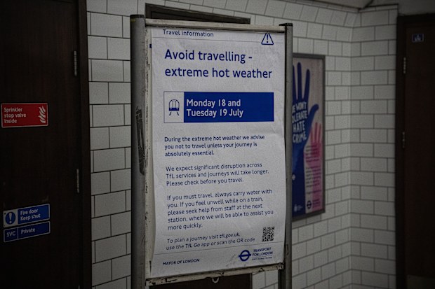 A notice in an underground train station warns people to avoid travelling where necessary because of the heat, on July 19, 2022 in London, England.  