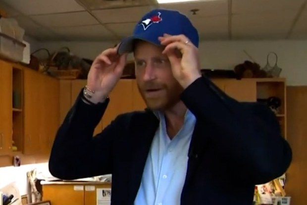 Prince Harry wears a Toronto Blue Jays baseball cap during an interview