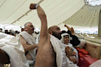 Masses of pilgrims have embarked on a symbolic stoning of the devil in Saudi Arabia under the soaring summer heat.