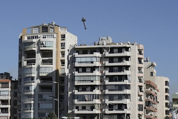 1 A missile launched from an Israeli jet hits a building in Ghobeiri, Beirut, Lebanon, Tuesday, Oct. 22, 2024. (AP Photo/Bilal Hussein)