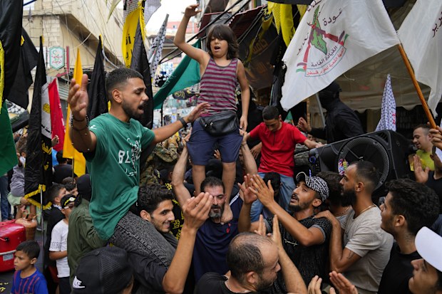 People dance in celebration of the attacks that the militant Hamas group carried out against Israel, at Bourj al-Barajneh Palestinian refugee camp, in Beirut, Lebanon, Saturday, Oct. 7, 2023.  