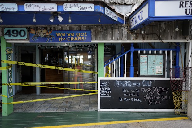 A chalkboard outside Duncan's on the Gulf reads "Closed Till Thurs Due to Hurricane Idalia. Be Safe," as business prepare for the expected arrival of Hurricane Idalia in Cedar Key, Fla, Tuesday, Aug. 29, 2023 