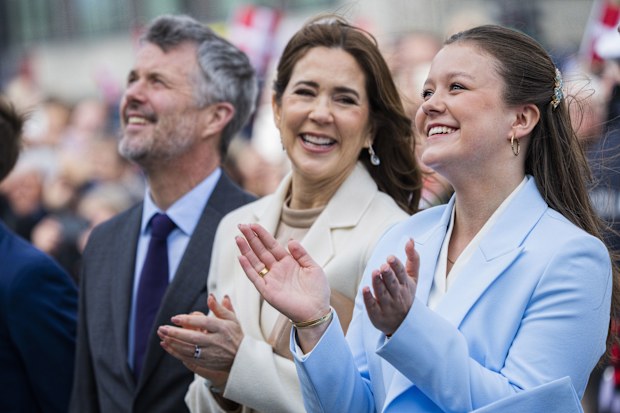 AARHUS, DENMARK - APRIL 11: (L-R) King Frederik X of Denmark, Queen Mary of Denmark and Princess Isabella of Denmark, watching a birthday surprise unfolding (a big happy birthday banner) in front of Aarhus City Hall to celebrate Princess Isabella Of Denmark's 18th birthday on April 11, 2025 in Aarhus, Denmark. (Photo by Martin Sylvest Andersen/Getty Images)