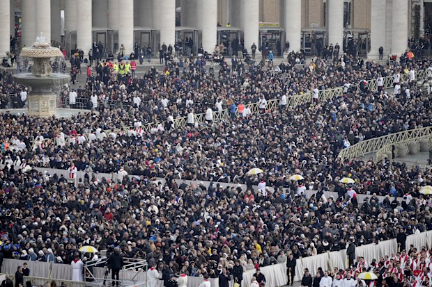 VATICAN CITY, VATICAN - JANUARY 05: Mourners attend the funeral mass for Pope Emeritus Benedict XVI at St. Peter's square on January 5, 2023 in Vatican City, Vatican. Former Pope Benedict XVI, who served as head of the Catholic Church from 19 April 2005 until his resignation on 28 February 2013, died on 31 December 2022 aged 95 at the Mater Ecclesiae Monastery in Vatican City. Over 135,000 people paid their tributes on the first two days of the late pontiff's lying in state at St. Peter's Basili