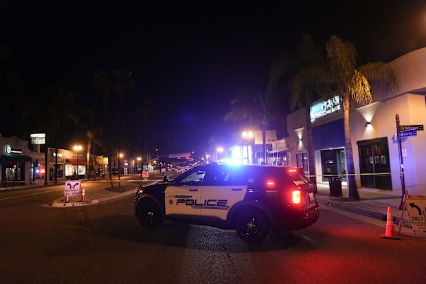 A police vehicle is seen near a scene where a shooting took place in Monterey Park, Calif., Sunday, Jan. 22, 2023. Dozens of police officers responded to reports of a shooting that occurred after a large Lunar New Year celebration had ended in a community east of Los Angeles late Saturday. (AP Photo/Jae C. Hong)