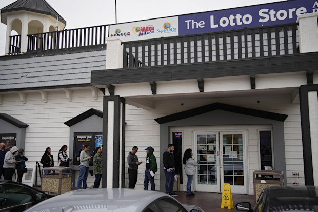 People wait in line at the Lotto Store at Primm just inside the California border, Friday, Jan. 13, 2023, near Primm, Nev. Mega Millions players will have another chance Friday night to end months of losing and finally win a jackpot that has grown to $1.35 billion