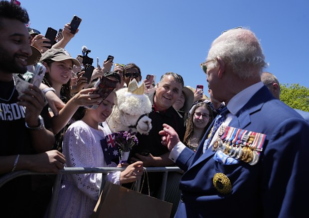 Britain's King Charles III, tight, chat with owner of alpaca before leave the Australian War Memorial in Canberra, Monday, Oct. 21, 2024.