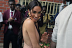 Meghan Markle gestures as she and Prince Harry visit children at the Lights Academy in Abuja, Nigeria, Friday, May 10, 2024.   