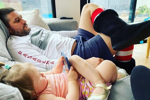 Brendan Fevola and Tobi watching TV