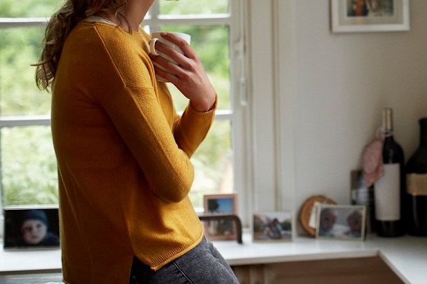 Woman drinking coffee at home