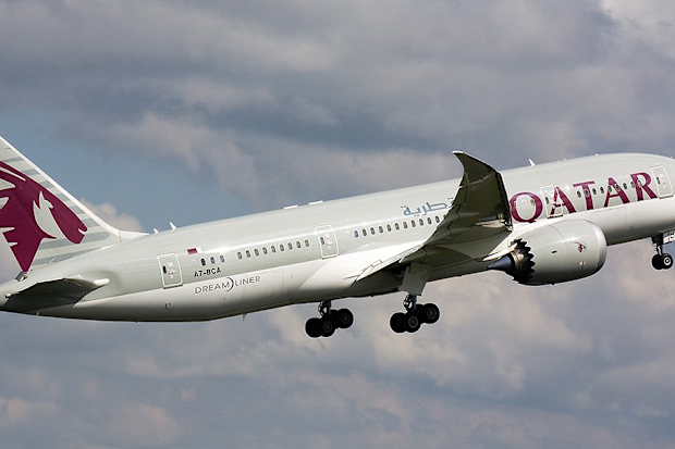 A Qatar Airways plane flying through the sky