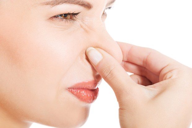 Woman holding nose