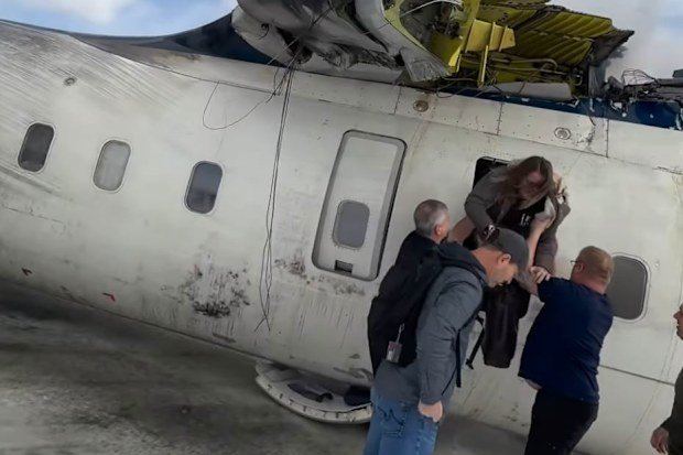 Passengers who survived a dramatic plane crash in Canada have recalled hanging upside down in the aircraft after it flipped on the runway.