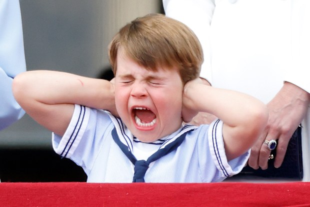 Prince Louis covers his ears whilst watching a flypast from the balcony of Buckingham Palace during Trooping the Colour on June 2, 2022 in London, England. 