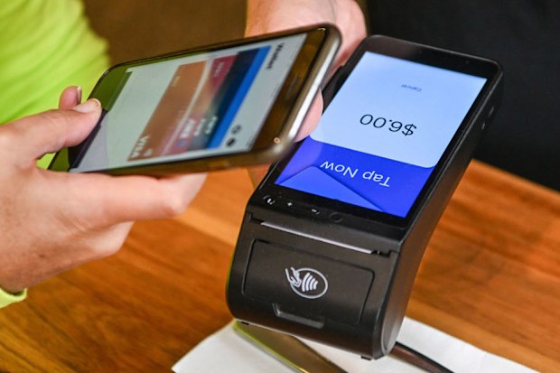 Someone makes a payment using their phone.