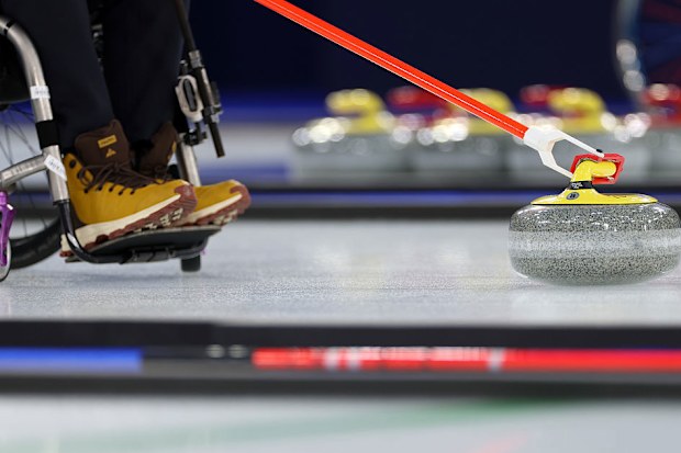 A detailed view of a curling stone and stick during a Wheelchair Curling mixed doubles round.