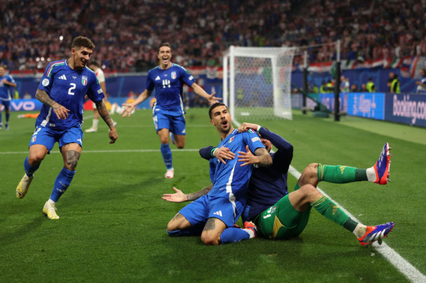 Mattia Zaccagni of Italy celebrates with teammates after scoring his team's first goal to equalise during the UEFA EURO 2024 group stage.
