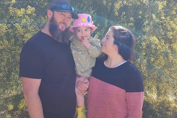 Izzy with her mum Amy and dad Matt.