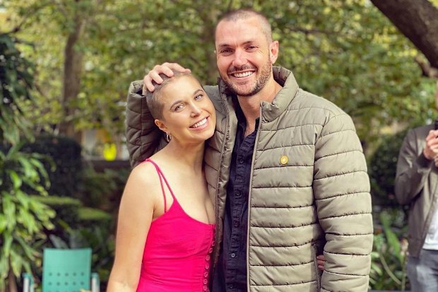 Hannah with Simon after they both shaved their heads.