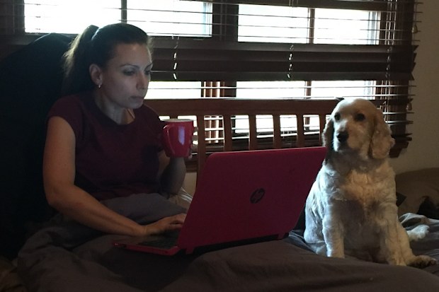 Jo Abi writing in bed with Sadie