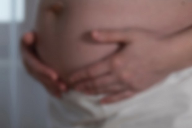 Woman holding her pregnant belly