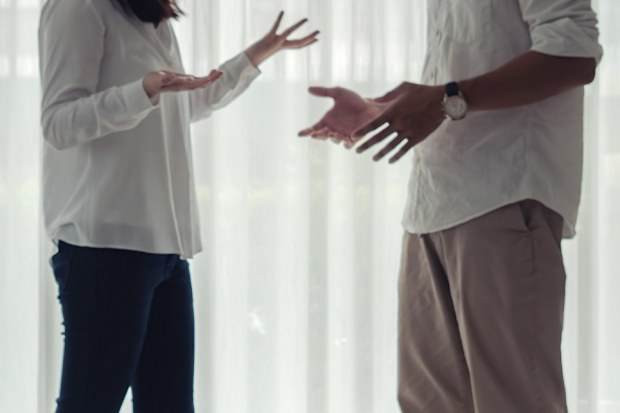 Asian depress girls sitting on the floor hugging her knees in sad moody while her father and mother arguing, family negative concept.