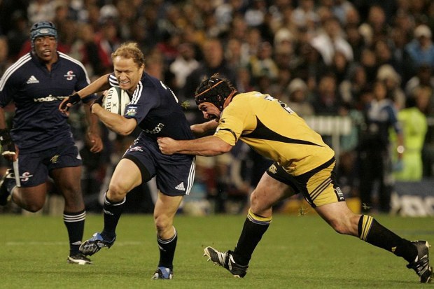 Tony Brown of the Stormers is stopped by Andrew Hore of the Hurricanes in 2008.
