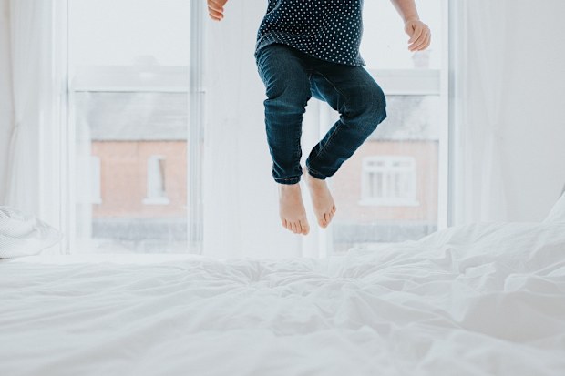 Child jumping on bed