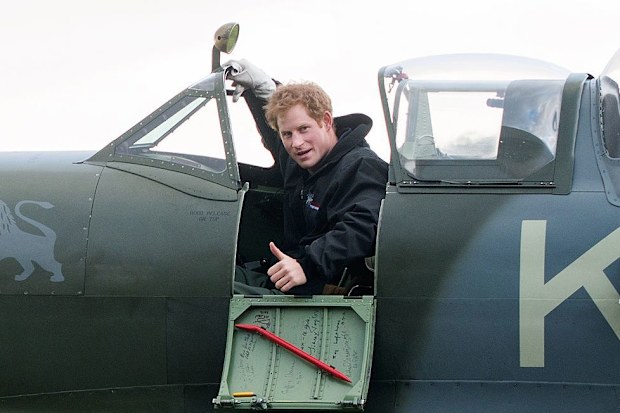 Prince Harry sits in a Spitfire plane as he visits Boultbee Flight Academy on February 15, 2014 in Goodwood, England 