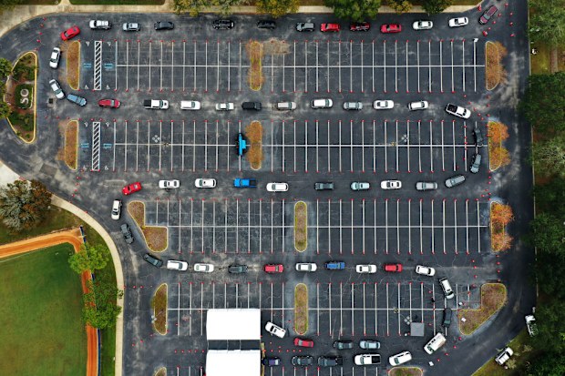Cars line up at a COVID-19 testing site at the South Orange Youth Sports Complex in Orlando.