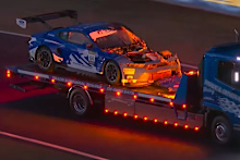 The battered Ford Mustang is towed back to the pits after Christopher Mies' high-speed encounter with a kangaroo.