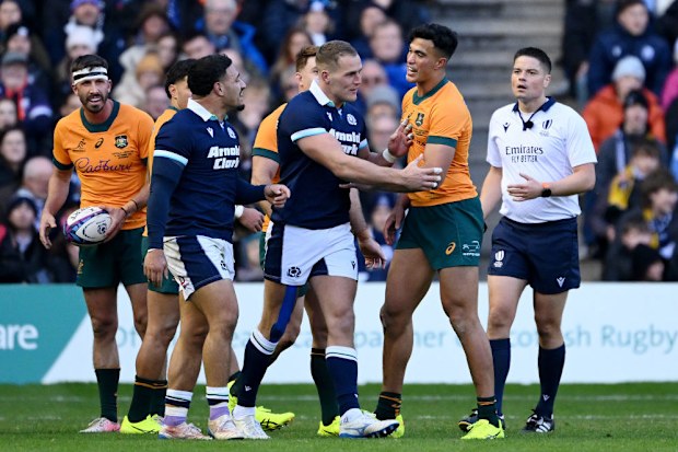 Joseph-Aukuso Suaalii of Australia clashes with Sione Tuipulotu of Scotland.