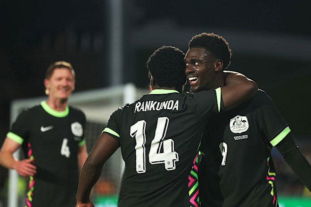 Mohamed Toure of Australia celebrates with teammate Nestory Irankunda.