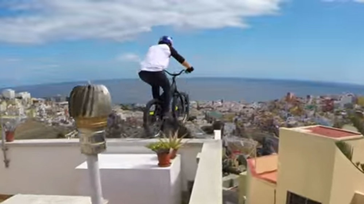 BMX rider tackles vertigo-inducing roof ride | Nine.com.au