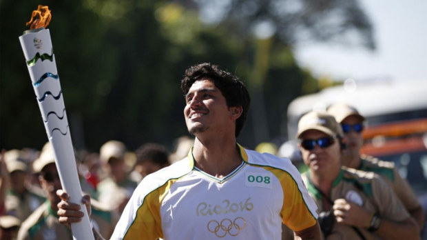 Former surfing world champ Gabriel Medina carries the Olympic torch. (Supplied) 