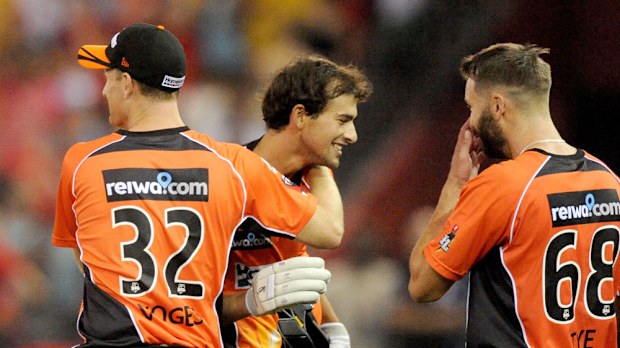 Ashton Agar is mobbed after hitting a six off the last ball to win the match. (AAP)