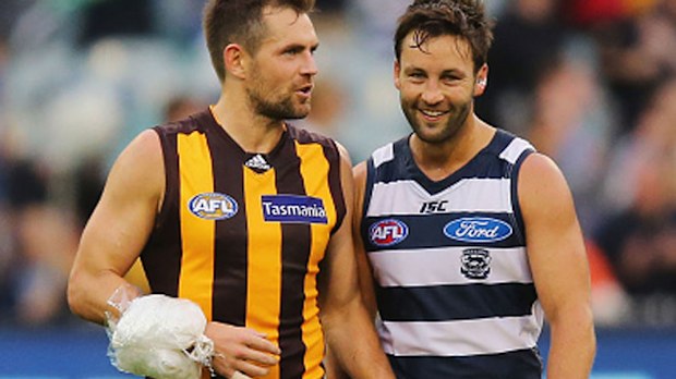 An iced-up Luke Hodge speaks with Jimmy Bartel after the loss. (Getty)
